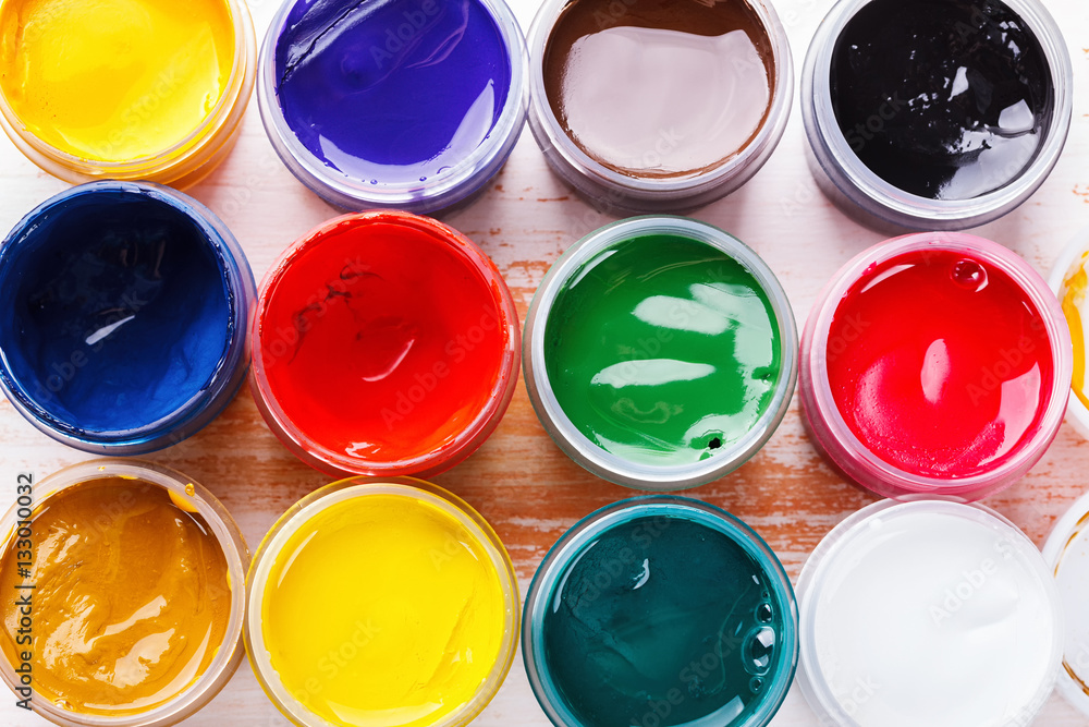 set of gouache paint on the painted wooden table set of gouache paint on the painted wooden table