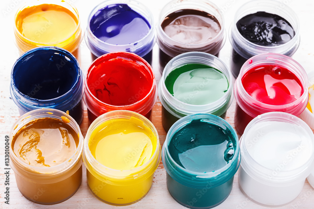 set of gouache paint on the painted wooden table set of gouache paint on the painted wooden table