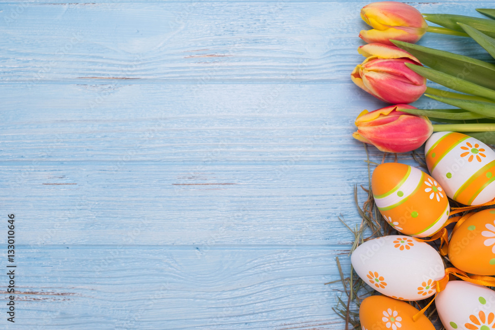 Easter eggs with Tulips on wooden background