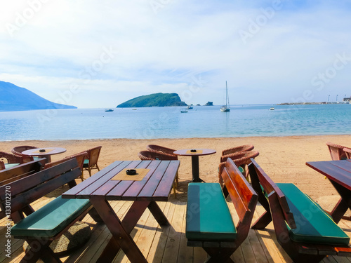 The empty tables on sea beach restaurant of Budva