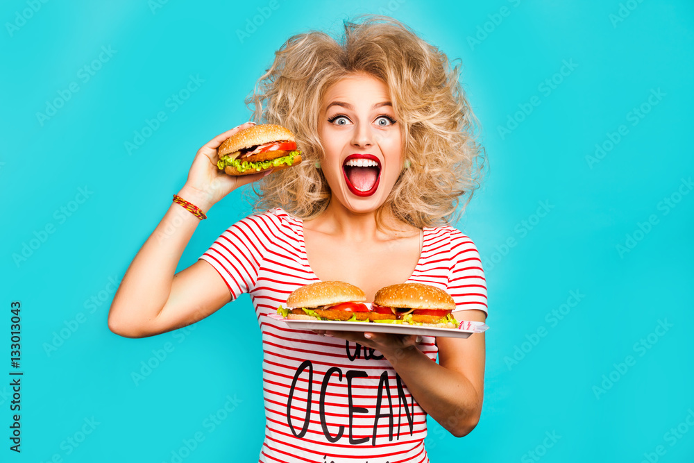 Fotografie Studio fashion portrait of a beautiful funny young girl on the turquoise backgro