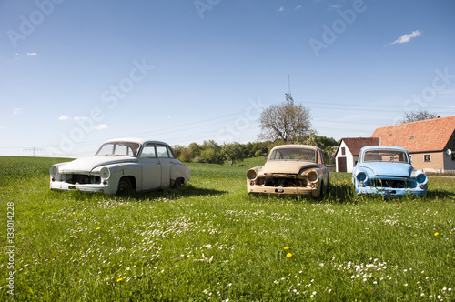 3 broken oldtimer on meadow