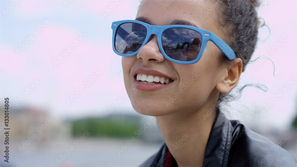 Closeup portrait of a beautiful Afro American woman in sunglasses, outdoor. Closeup portrait of a beautiful Afro American woman in sunglasses, outdoor.