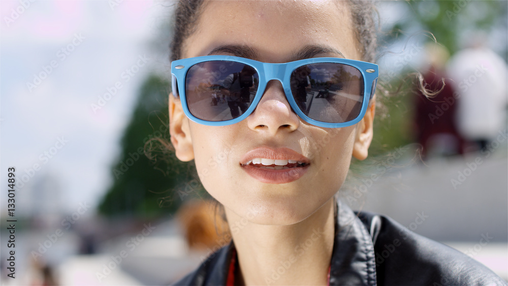 Closeup portrait of a beautiful Afro American woman in sunglasses, outdoor. Closeup portrait of a beautiful Afro American woman in sunglasses, outdoor.