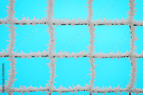 Net in the frost on a blue background