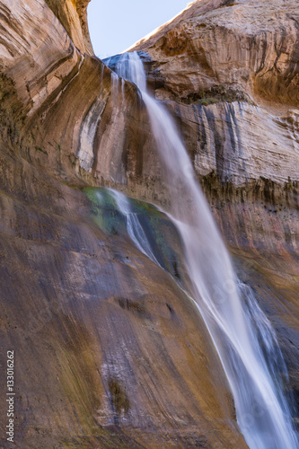 Lower Calf Creek Falls Side View - A breath-taking  beautiful  cool  130 foot desert waterfall at the end of a canyon grotto as seen from the side. Boulder  Utah.