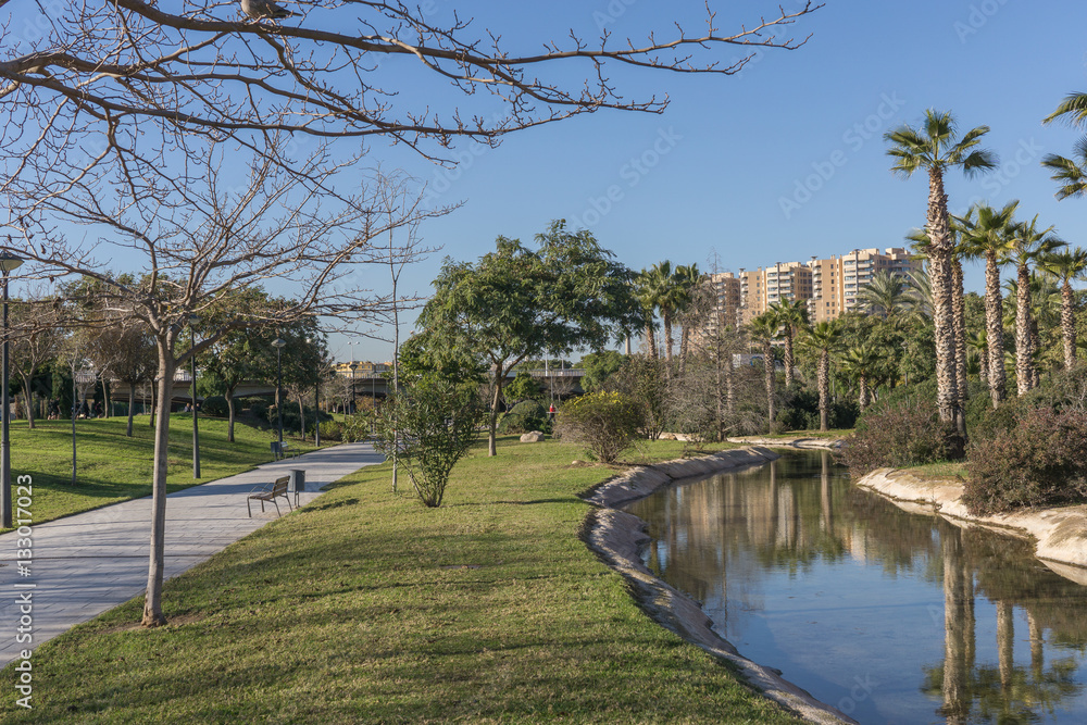 Turia River gardens Jardin del Turia, leisure and sport area. Pedestrian walk way and artificial water channel. Valencia, Spain Turia River gardens Jardin del Turia, leisure and sport area. Pedestrian walk way and artificial water channel. Valencia, Spain