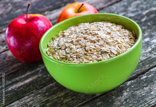 Oatmeal or oat flakes on dark wooden table © bukhta79