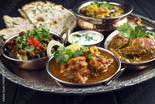 Traditional Indian Curry Dishes as close-up on Thali