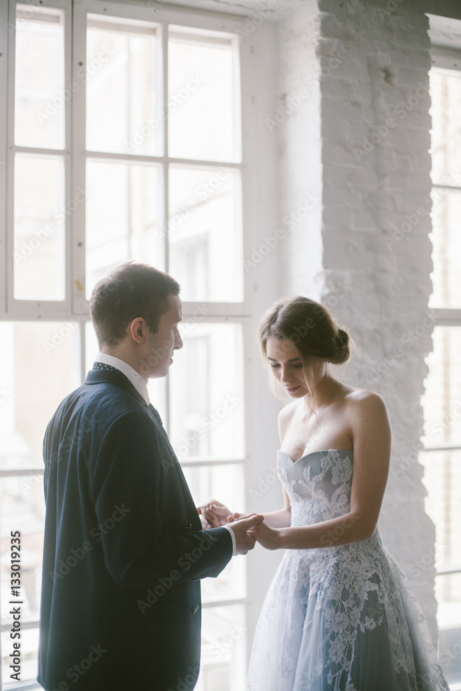 The newly-married couple holding hands. Bridal fashion. The newly-married couple holding hands. Bridal fashion.