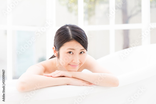 young asian woman relaxing in bathtub