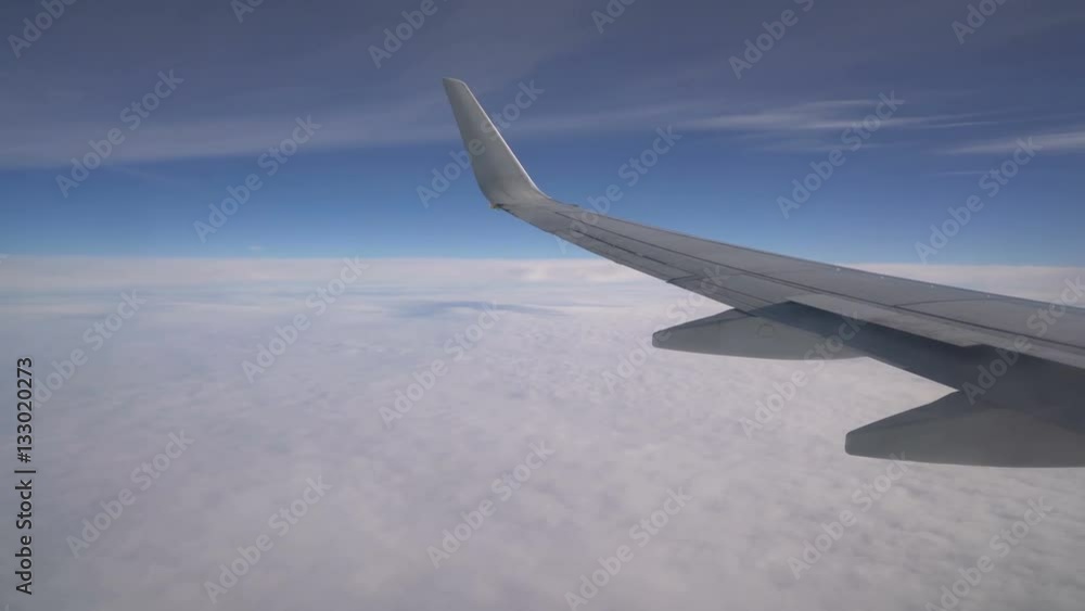 Wing of an airplane above the clouds Wing of an airplane above the clouds