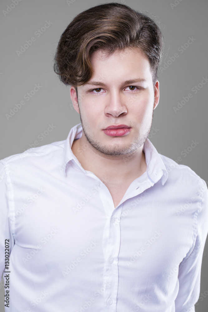 Obraz premium Elegant young handsome man in white shirt
