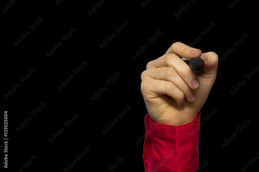 Fototapeta premium Hand holding marker isolated on black