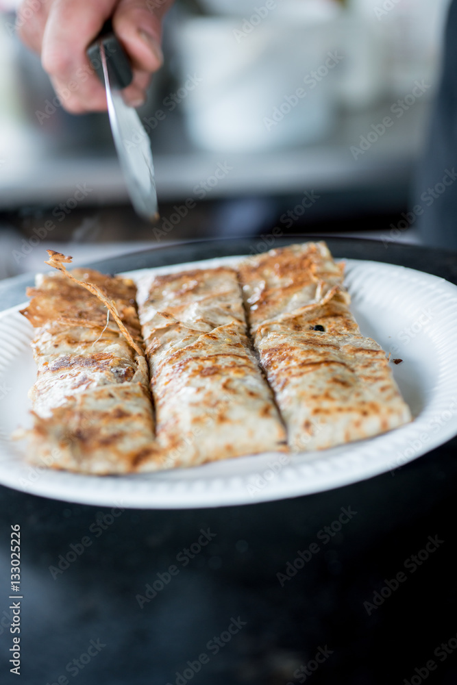 Crepe in Paper Plate Sliced into Three with Knife Crepe in Paper Plate Sliced into Three with Knife