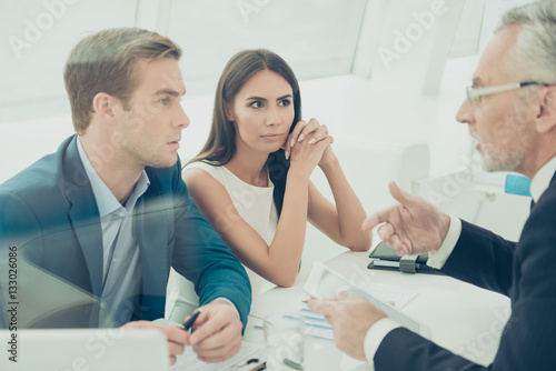 Three businesspeople sitting at office and having business meeti photo