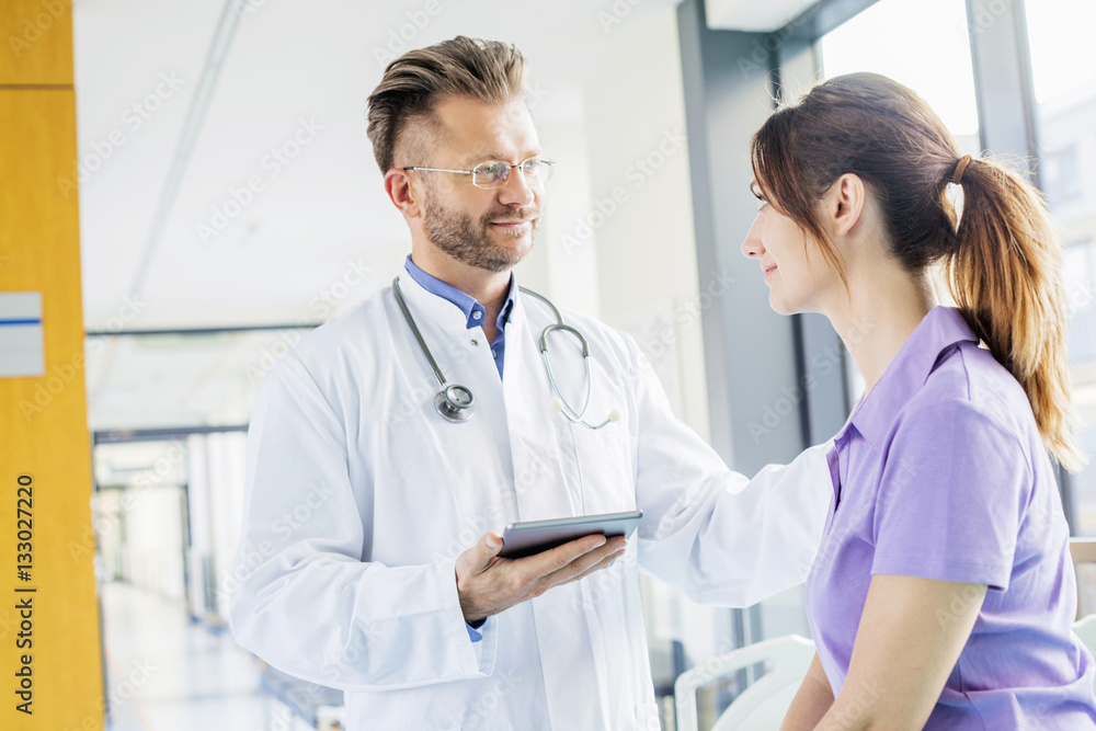 Doctor tapping coworker on the shoulder Doctor tapping coworker on the shoulder