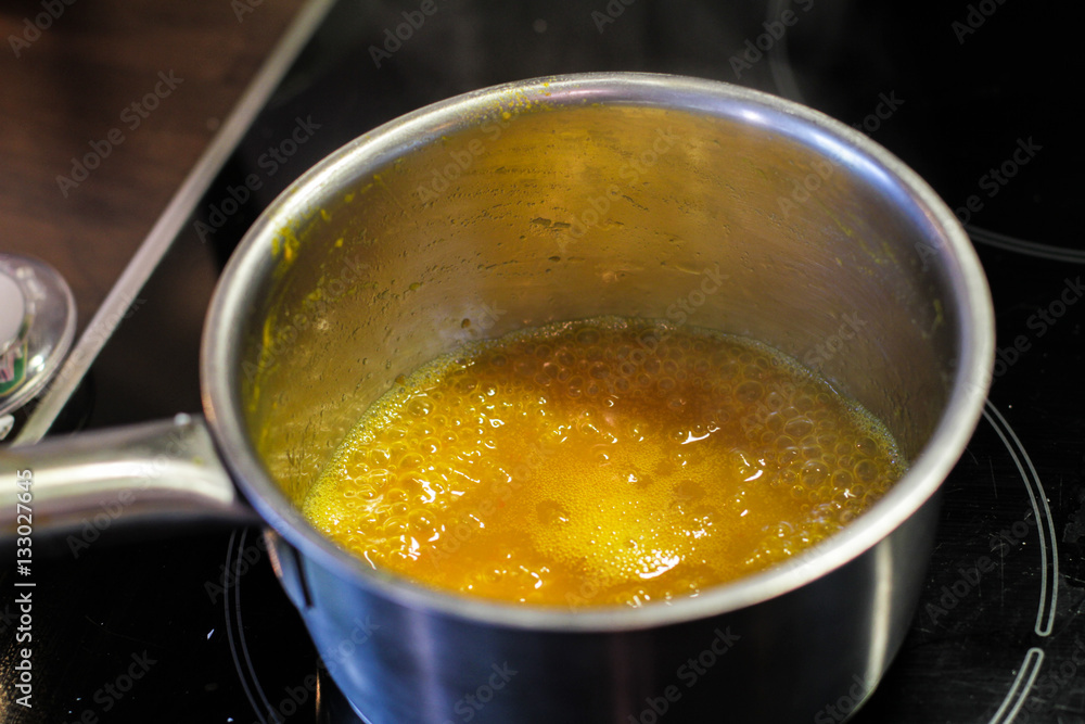 Yellow sauce in the metal sause pan boiling Yellow sauce in the metal sause pan boiling