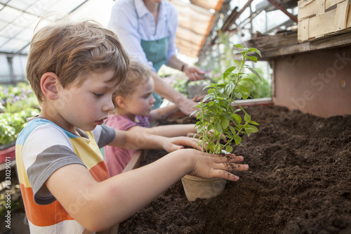 Wallpaper Mural Female gardener and children in greenhouse Torontodigital.ca