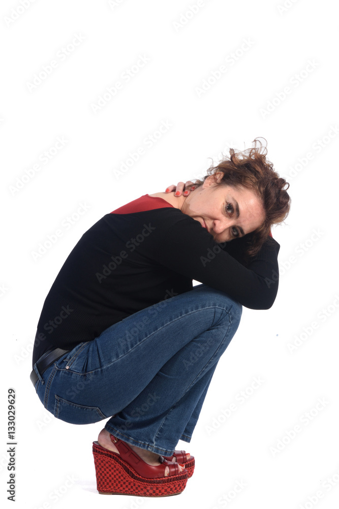 Woman crouching on a white background Woman crouching on a white background
