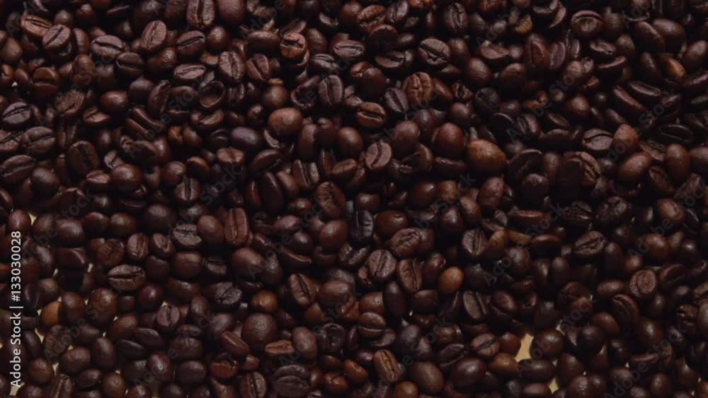 Coffee beans on a wooden table. Background of falling coffee beans. Heart of the coffee beans Slow motion 240 fps.Slowmo. Coffee beans on a wooden table. Background of falling coffee beans. Heart of the coffee beans Slow motion 240 fps.Slowmo.