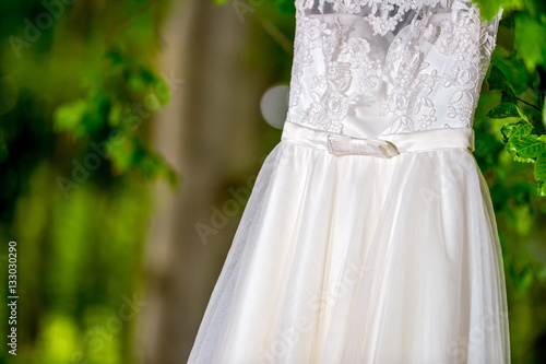 Wedding dress hanging in natural light