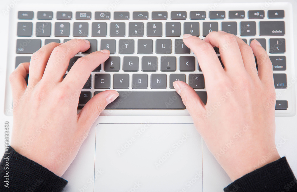 Closeup woman typing on laptop computer Closeup woman typing on laptop computer