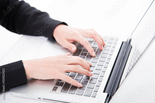 Closeup woman typing on laptop computer