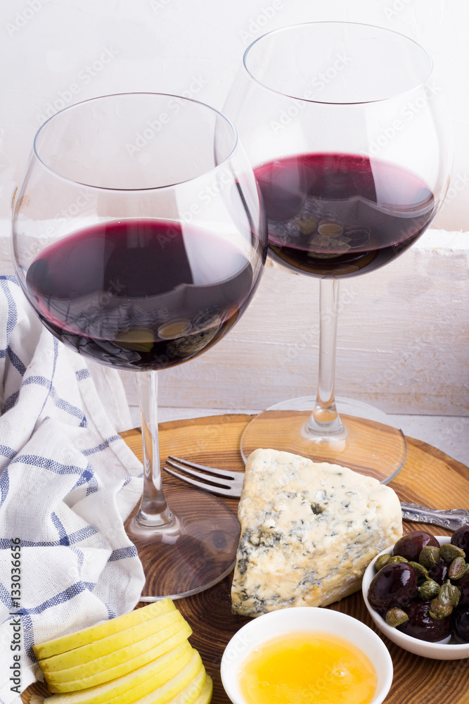 red wine and appetizers on a tray