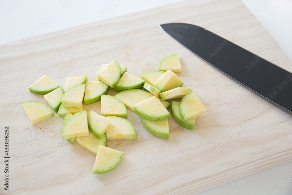 Diced zucchini, courgetti on a cutting board Diced zucchini, courgetti on a cutting board