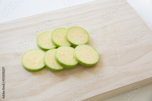 Sliced zucchini, courgetti on a cutting board