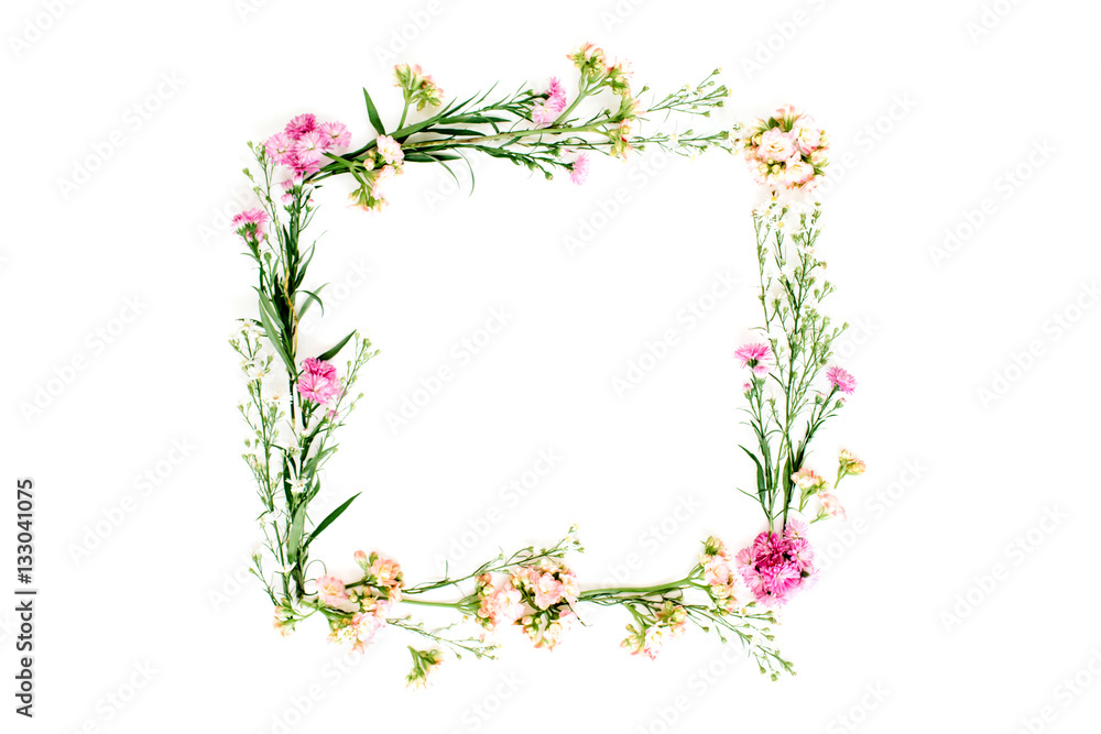 Wreath frame made of pink and beige wildflowers, green leaves, branches on white background. Flat lay, top view. Valentine's background