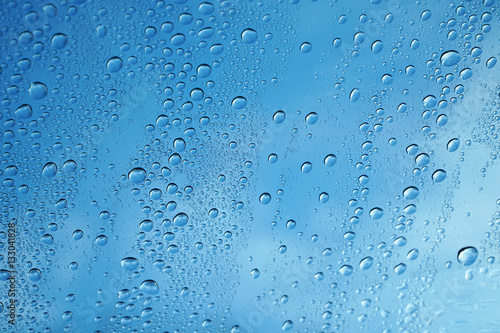 rain drop on glass background against blue sky