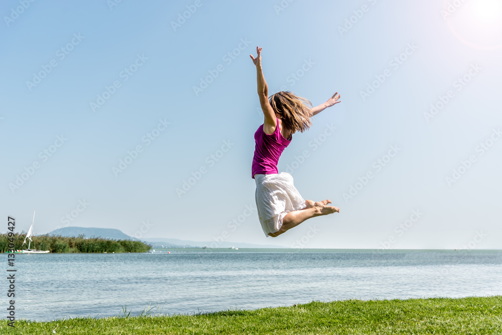 Girl jumping on the lake