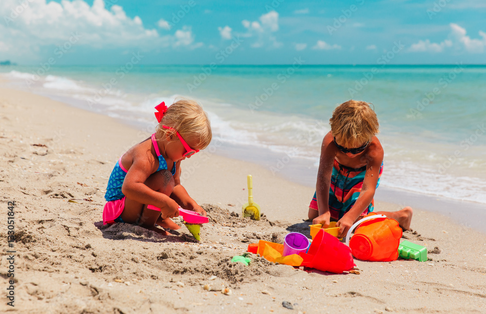 kids play with sand on summer beach kids play with sand on summer beach