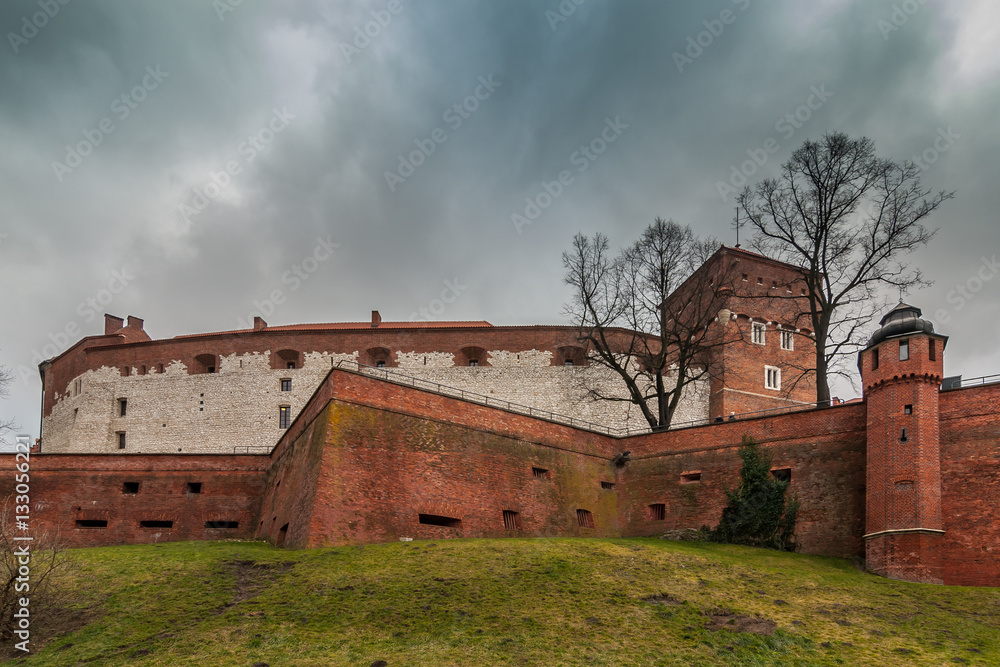 Castle walls against the background of the dark cloudy sky. Poland. Krakow. Wawel Castle walls against the background of the dark cloudy sky. Poland. Krakow. Wawel