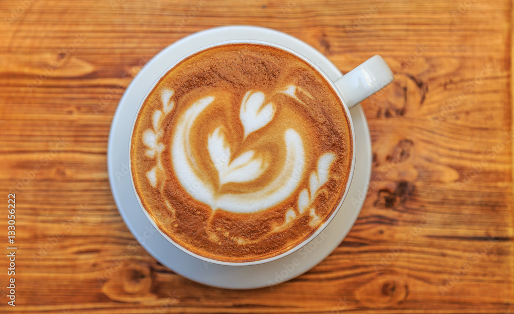 Big cup of cappuccino on a wooden background Big cup of cappuccino on a wooden background