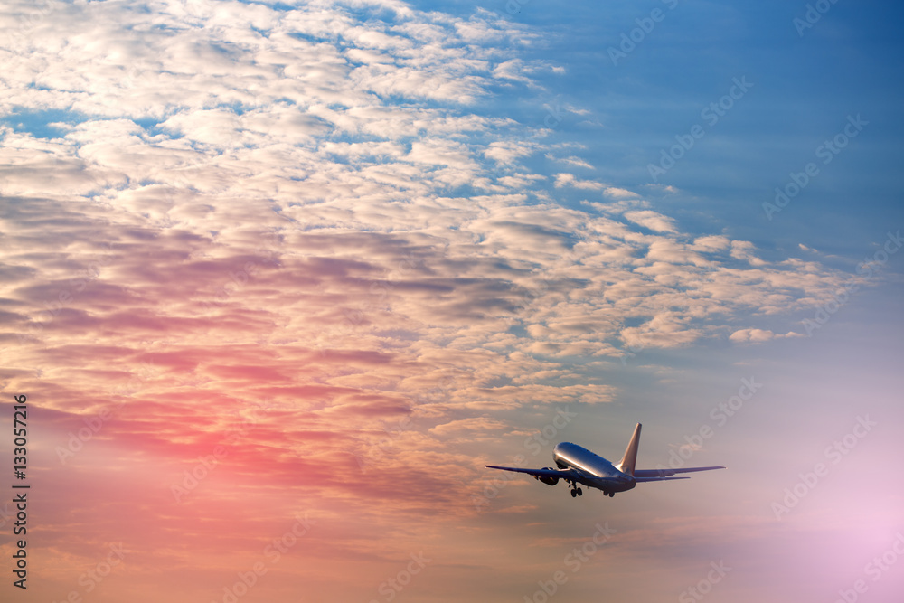 Airplane taking off at the sunset sky Airplane taking off at the sunset sky
