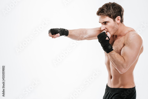 Young man boxer make boxing exercises © Drobot Dean