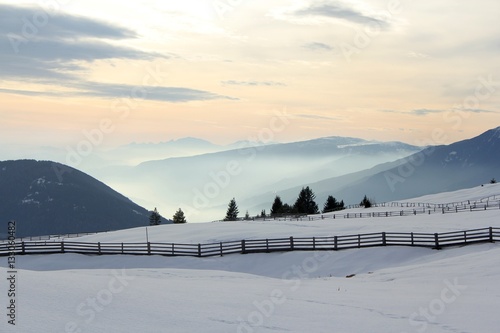 landscape from alpe di rodengo/rodeneck to isarco/eisack valley, wintertime in japanese patter style light, south tirol, italy photo