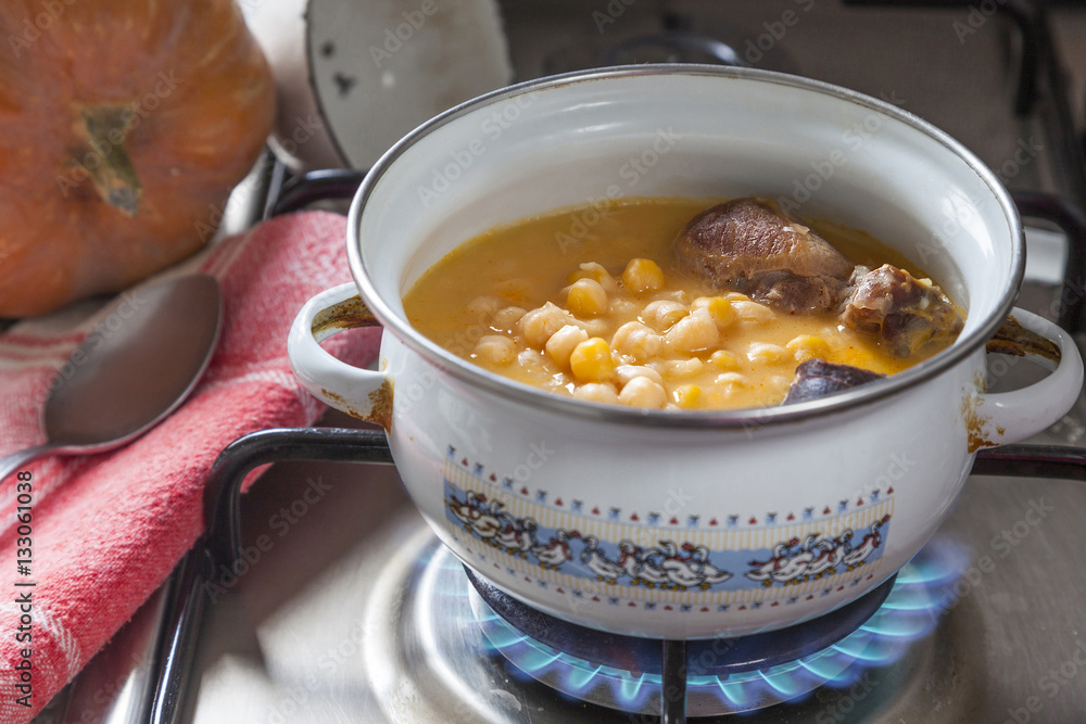 Chickpea stew in a saucepan, spanish cocido Chickpea stew in a saucepan, spanish cocido