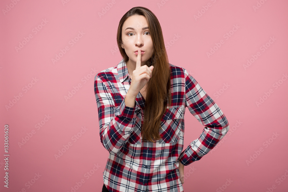 pretty girl showing quiet sign over pink background isolated pretty girl showing quiet sign over pink background isolated