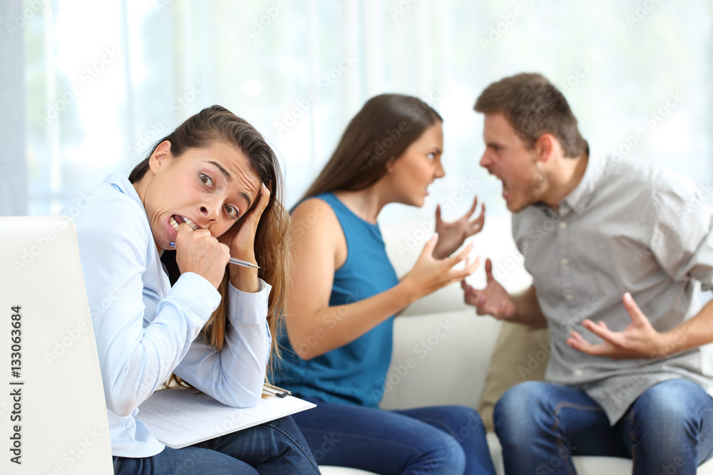 Couple arguing in theraphy driving crazy the therapist Couple arguing in theraphy driving crazy the therapist
