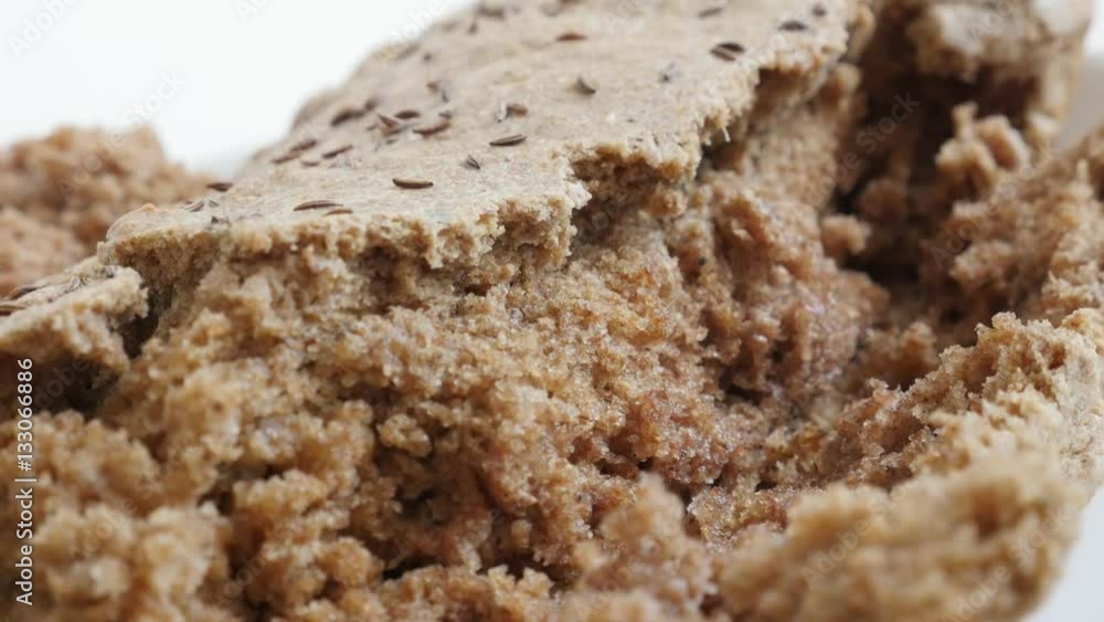 Tilting over tasty bread brown crust and inside made from full healthy grain and barley 4K 2160p 30fps UltraHD footage - Slow tilt on rustic staple food served on plate 3840X2160 UHD video Tilting over tasty bread brown crust and inside made from full healthy grain and barley 4K 2160p 30fps UltraHD footage - Slow tilt on rustic staple food served on plate 3840X2160 UHD video