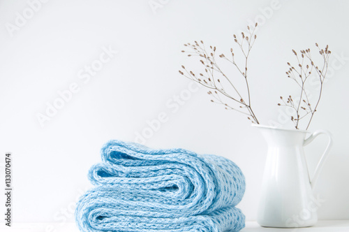 Minimal elegant composition with blue scarf and white vase photo