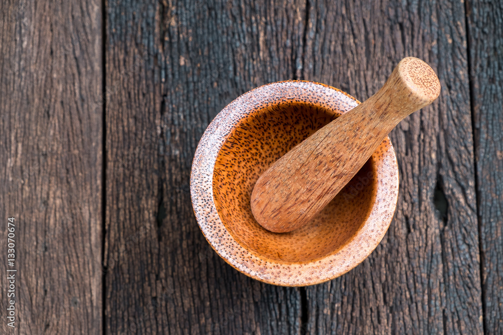 asia antique style wooden mortar with wooden pestle on old wood table. asia antique style wooden mortar with wooden pestle on old wood table.