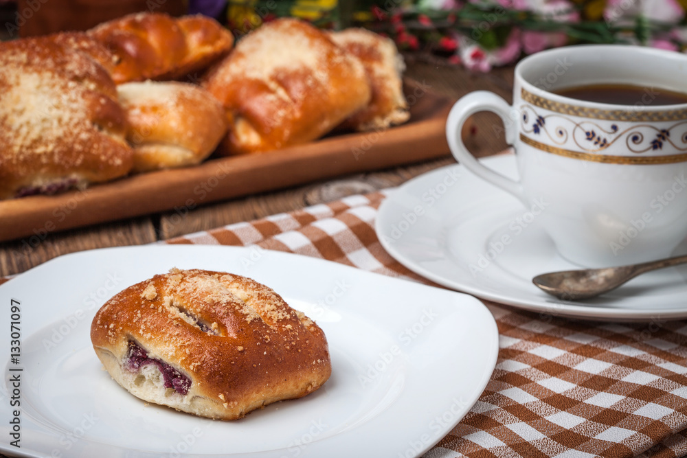 Buns with berries on a wooden table. Buns with berries on a wooden table.