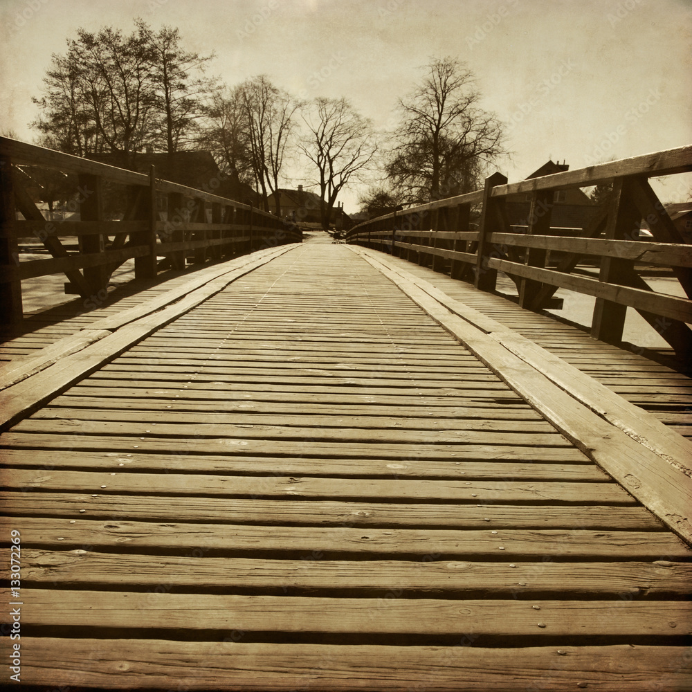 Obraz premium Grunge image of wooden bridge.