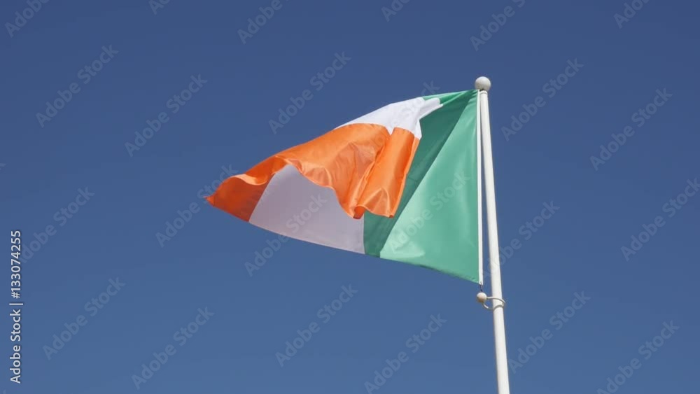 Slow motion tricolour striped shiny Ireland flag against blue sky on wind 1920X1080 HD footage - Orange white and green fabric of Irish national symbol slow-mo FullHD video Slow motion tricolour striped shiny Ireland flag against blue sky on wind 1920X1080 HD footage - Orange white and green fabric of Irish national symbol slow-mo FullHD video