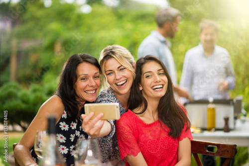 Group of female friends in their thirties taking a selfie